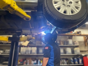 Quality Auto Mart & Service technician doing an inspection